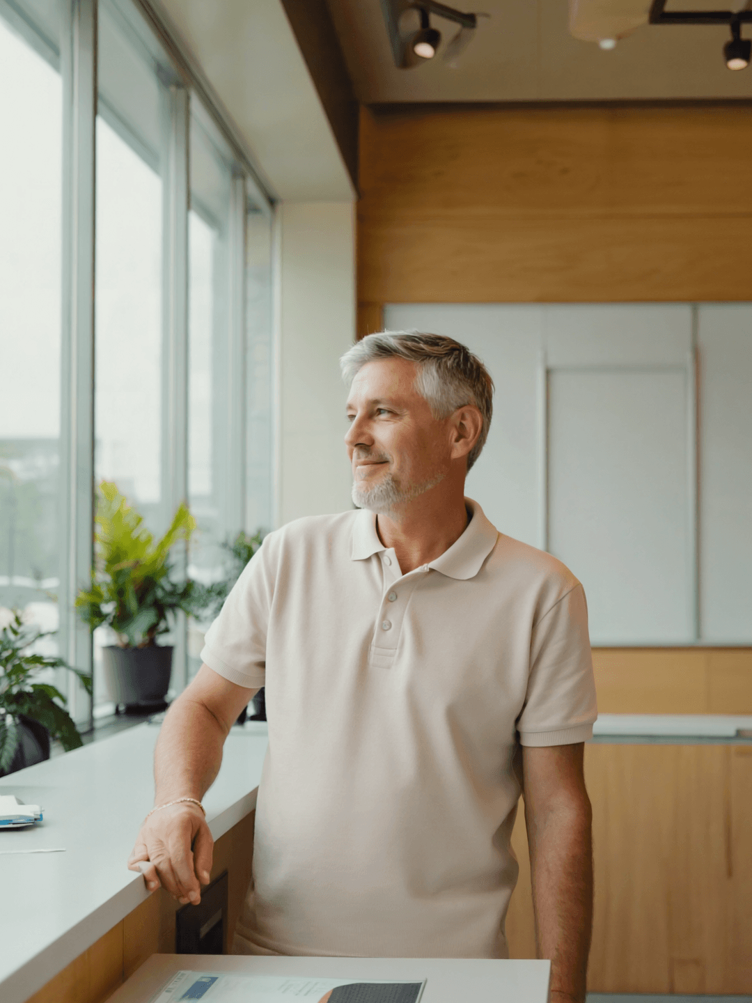 A man in his fifties at the reception desk of a bright leisure centre