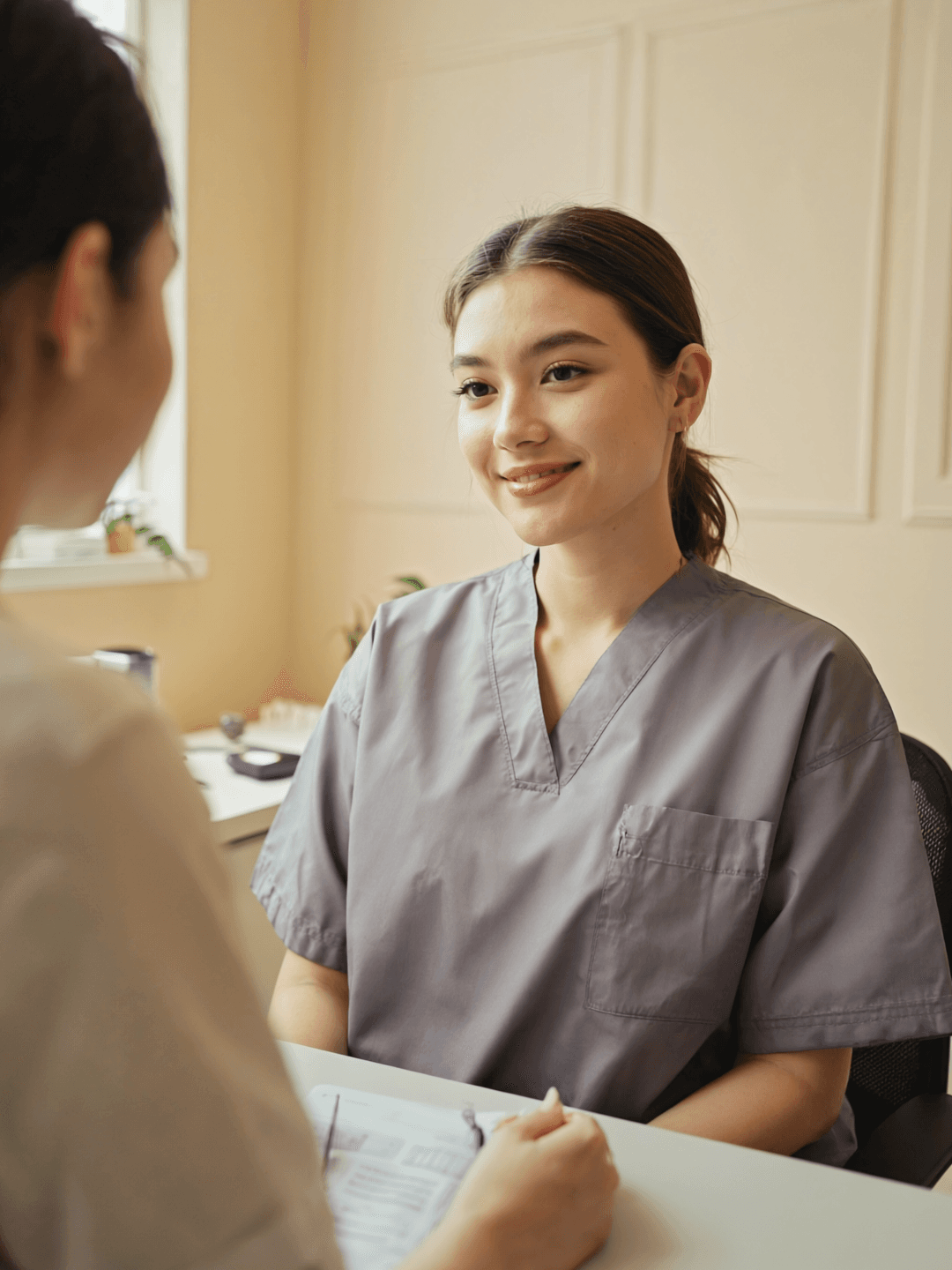 A practitioner greeting someone in a small private consulting room